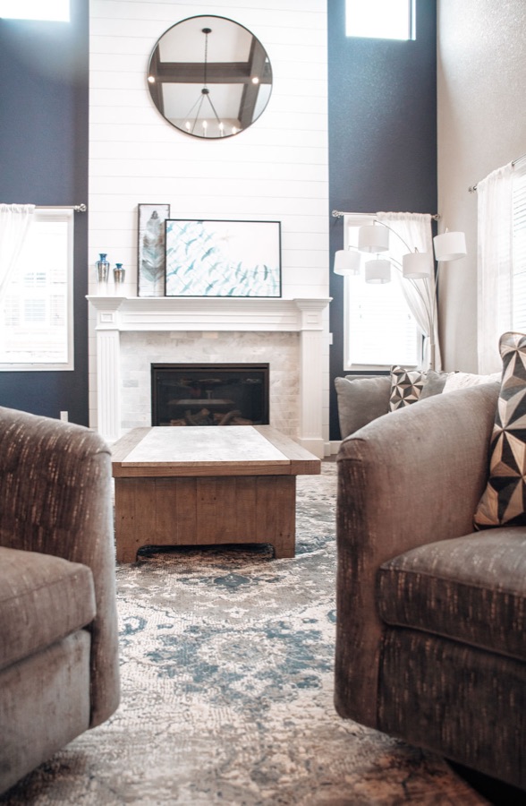 Faux wood beam ceiling with iron ring chandelier — Blackstone family room renovation in Aurora, Colorado