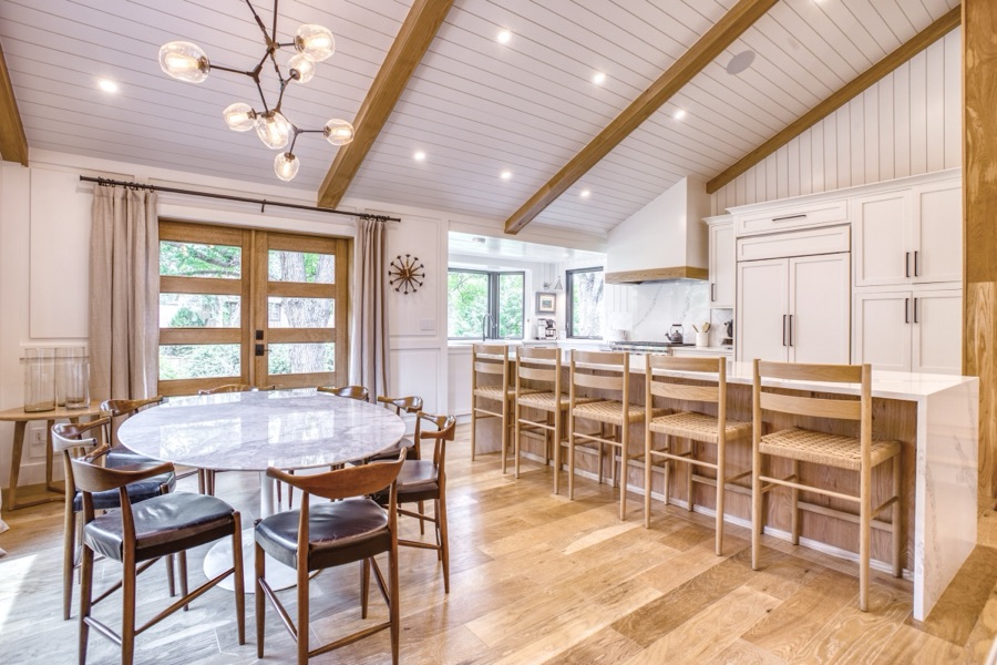 Vaulted kitchen and dining with white oak beams, shiplap ceiling, and waterfall island — Fulton Street whole house renovation in Greenwood Village