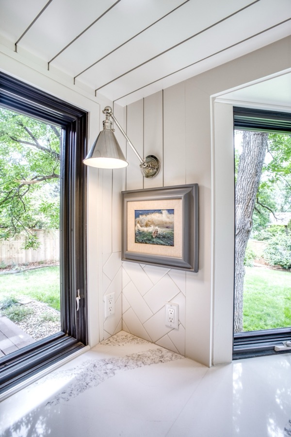 Kitchen perimeter with quartz counters and window to the trees — Fulton Street whole house renovation in Greenwood Village