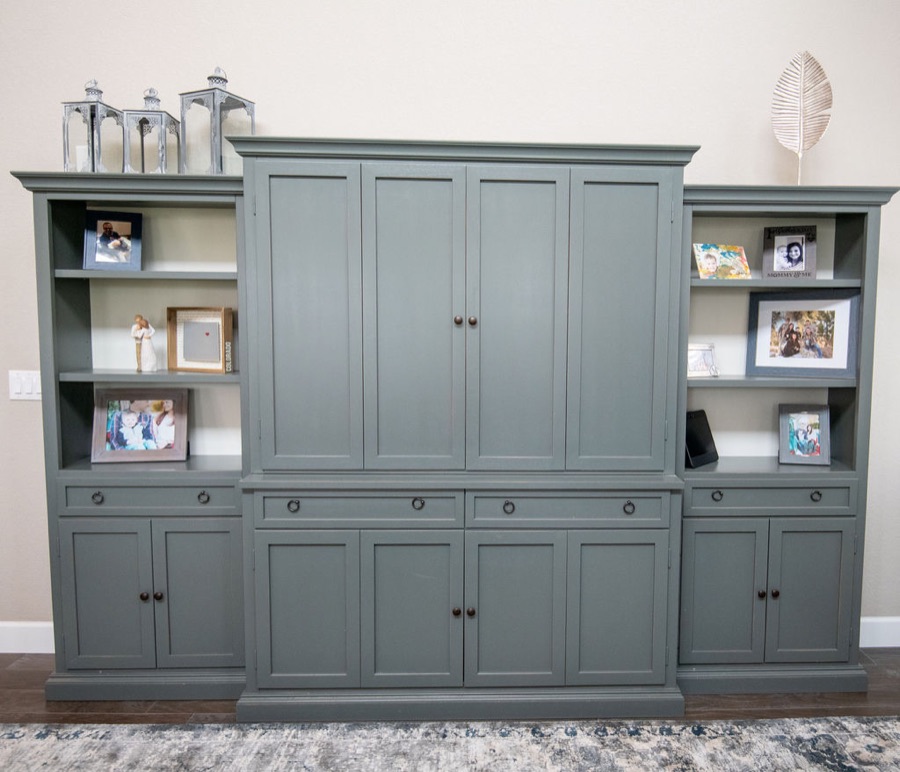 Sage entertainment center with concealed TV storage — Blackstone family room renovation in Aurora, Colorado