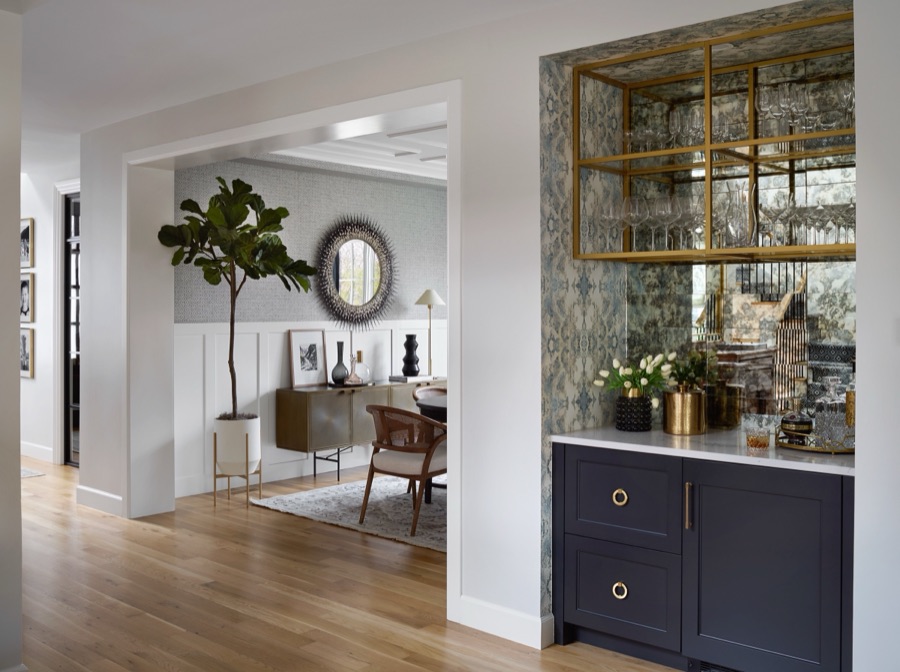 View through to the bar and dining room with white oak floors and navy accents — Bonnie Brae whole home renovation in Denver