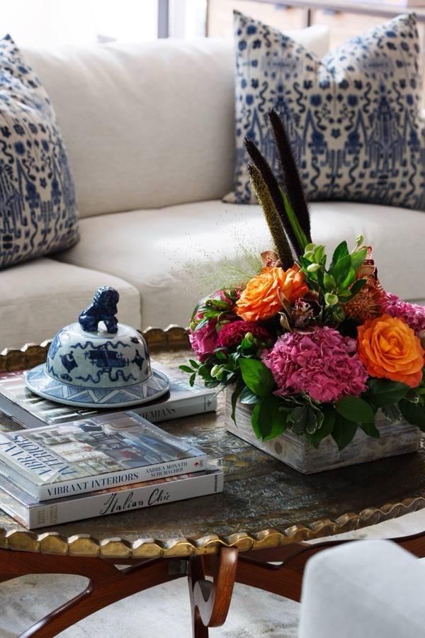 Coffee-table styling with fresh flowers, books, and collected objects — Greenwood Village hidden-detail whole home renovation
