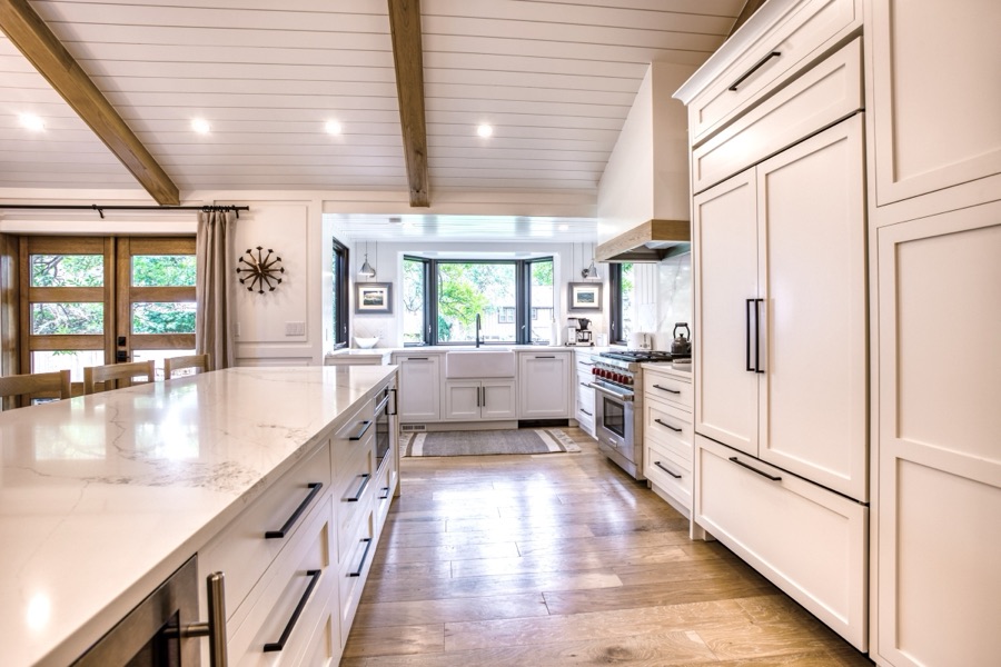 Marble-look island with panel-front appliances and white inset cabinetry — Fulton Street whole house renovation in Greenwood Village