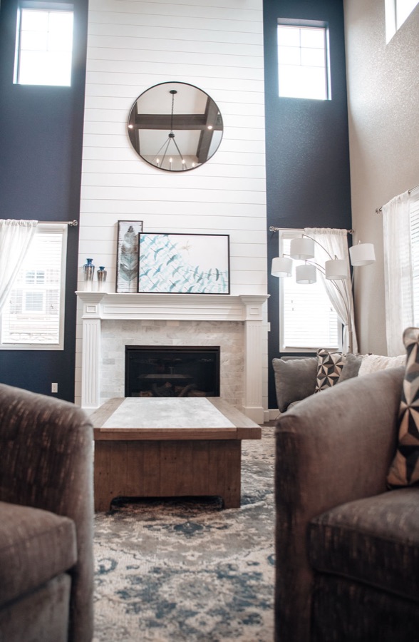 Mantle styling with vases and coastal art — Blackstone family room renovation in Aurora, Colorado