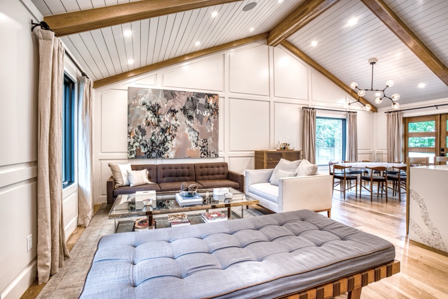 Living room with paneled feature wall, daybed, and layered art — Fulton Street whole house renovation in Greenwood Village