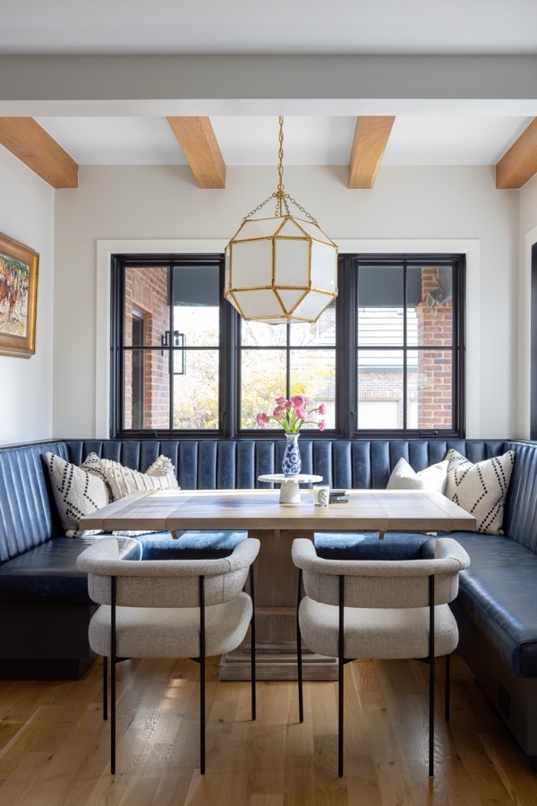 Breakfast nook banquette with cream swivel chairs and black-framed windows — Bonnie Brae whole home renovation in Denver