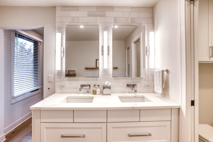 Double vanity with inset cabinets and sconce lighting — Fulton Street whole house renovation in Greenwood Village