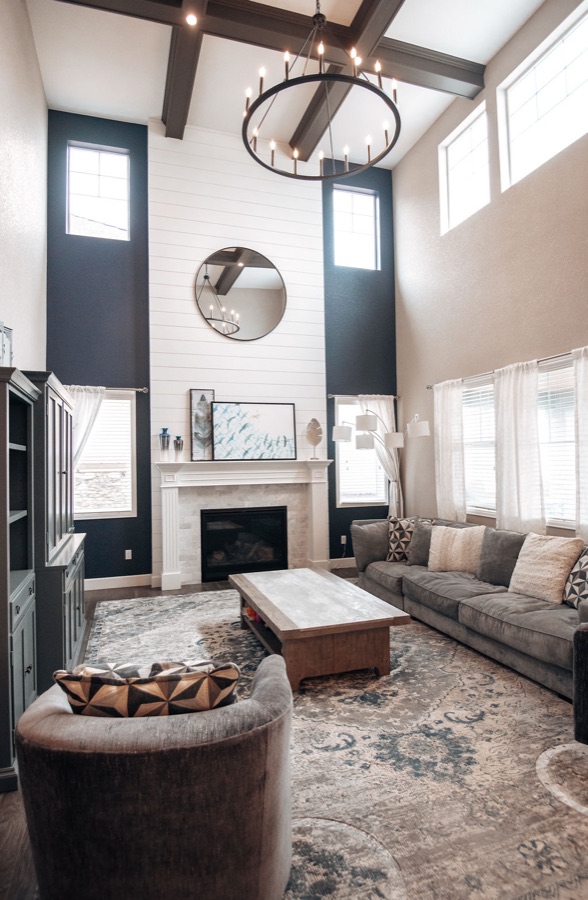 Family room with navy accent walls and layered blue rug — Blackstone family room renovation in Aurora, Colorado