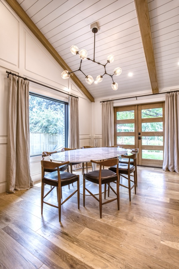 Breakfast nook with round table and mid-century chairs by the window — Fulton Street whole house renovation in Greenwood Village
