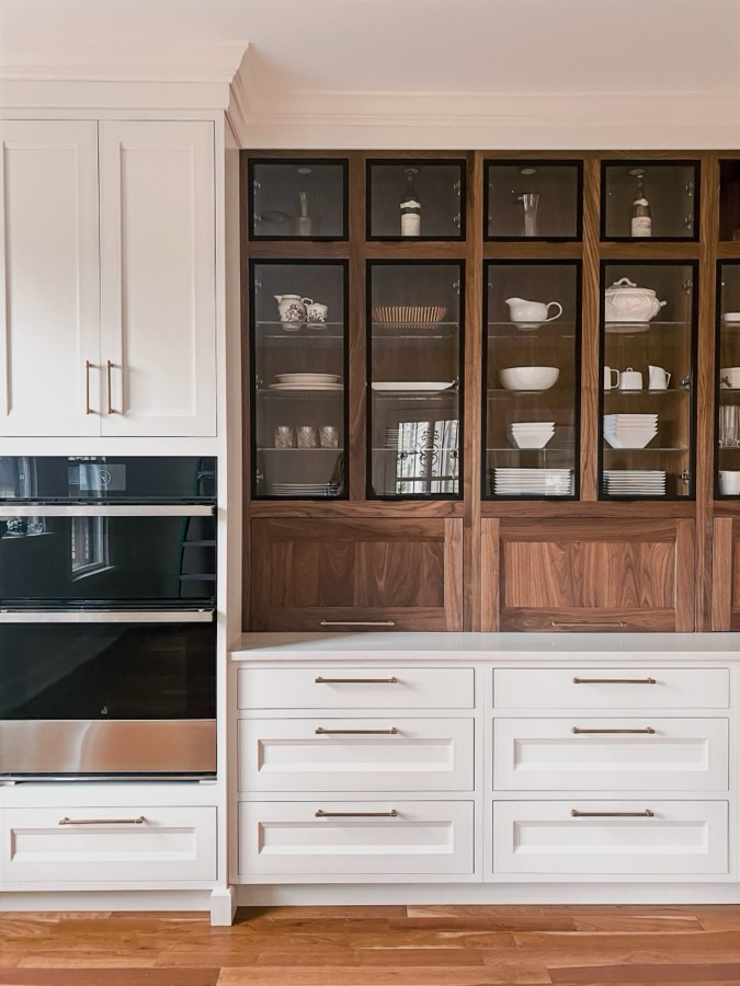 White inset cabinetry with walnut-and-glass upper display hutch — historic Colorado Springs kitchen remodel