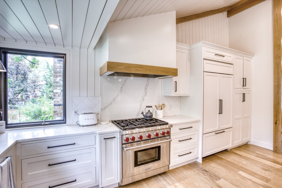 Range and custom hood with warm wood trim — Fulton Street whole house renovation in Greenwood Village