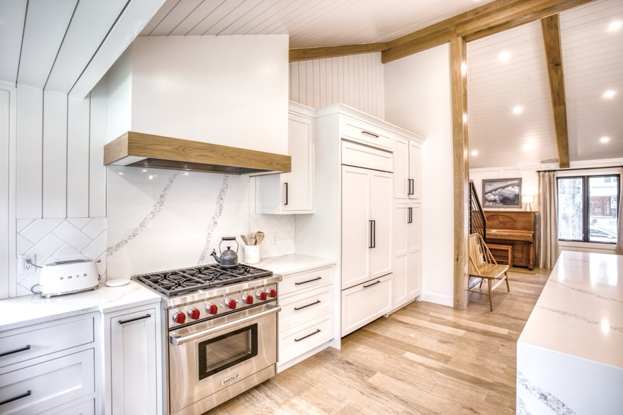 Range wall with white oak hood shelf and pro-style range — Fulton Street whole house renovation in Greenwood Village