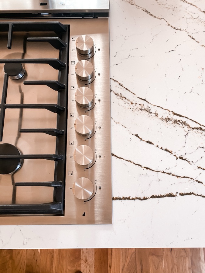Gas cooktop set into veined quartz counters — historic Colorado Springs kitchen remodel