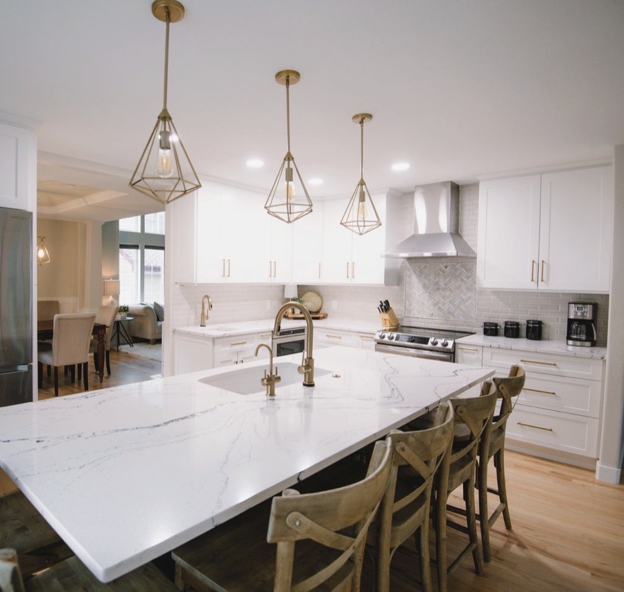 Island seating for family gatherings with wood cross-back stools — Stonegate main floor renovation in Parker, Colorado