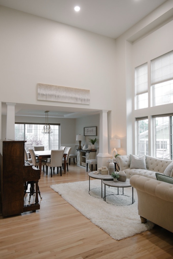 Casual dining and living flow with white oak floors — Stonegate main floor renovation in Parker, Colorado