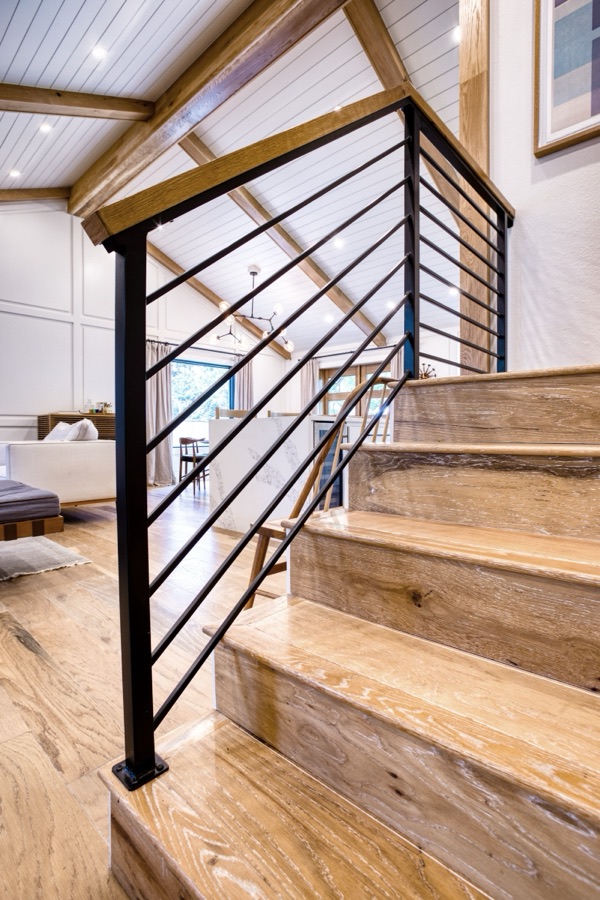 Staircase with horizontal iron rail and white oak treads — Fulton Street whole house renovation in Greenwood Village