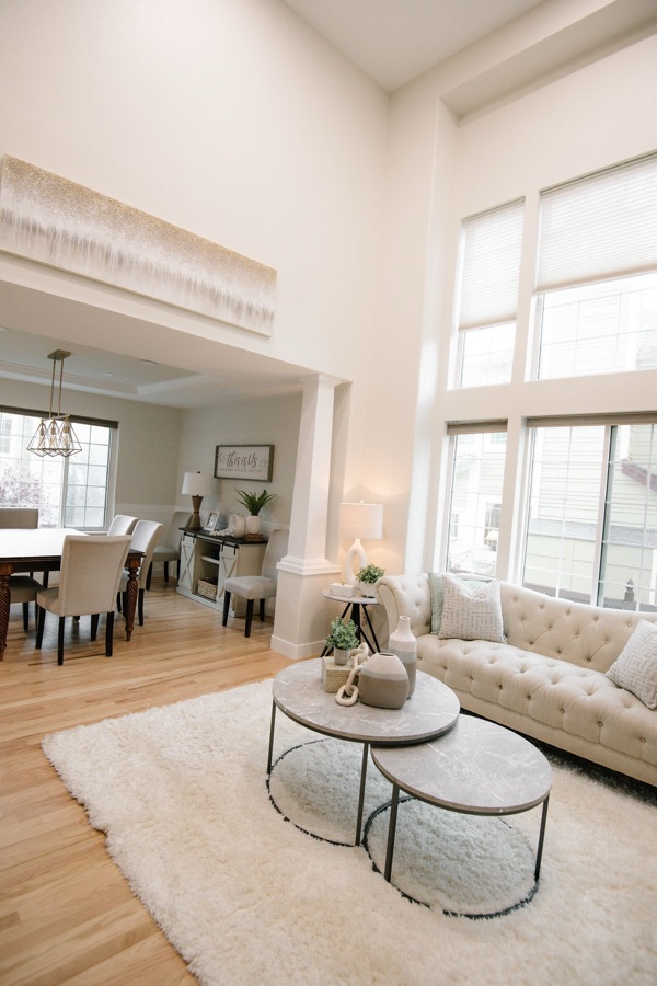 Dining room with wainscoting and airy drapery — Stonegate main floor renovation in Parker, Colorado