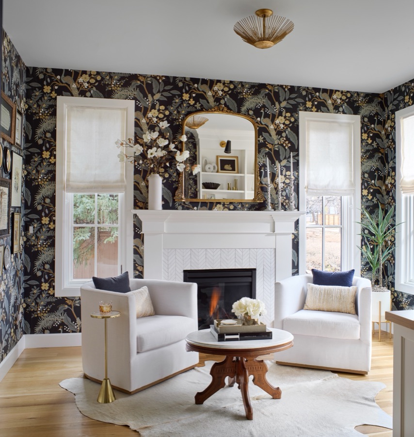 Her office with dark floral wallpaper, white armchairs, and antique wood coffee table — Bonnie Brae whole home renovation in Denver