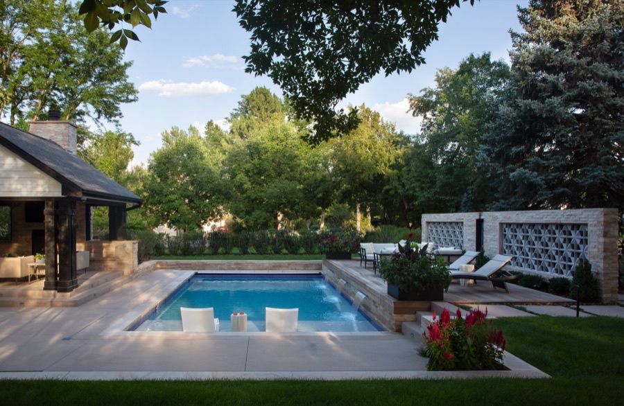 Outdoor entertaining space with pool, fire table, and tiered patio — Greenwood Village hidden-detail whole home renovation