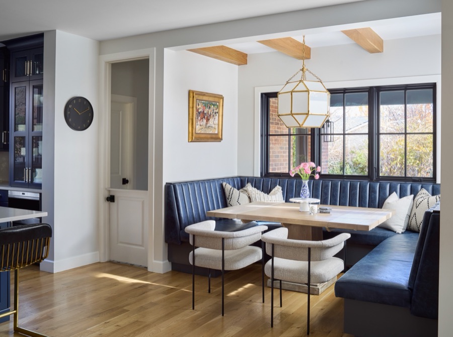 Channel-tufted navy leather banquette breakfast nook with brass lantern pendant — Bonnie Brae whole home renovation in Denver