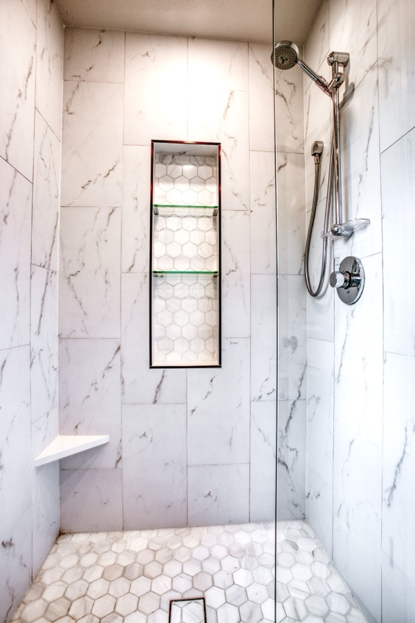 Primary vanity wall with backlit mirrors — Fulton Street whole house renovation in Greenwood Village