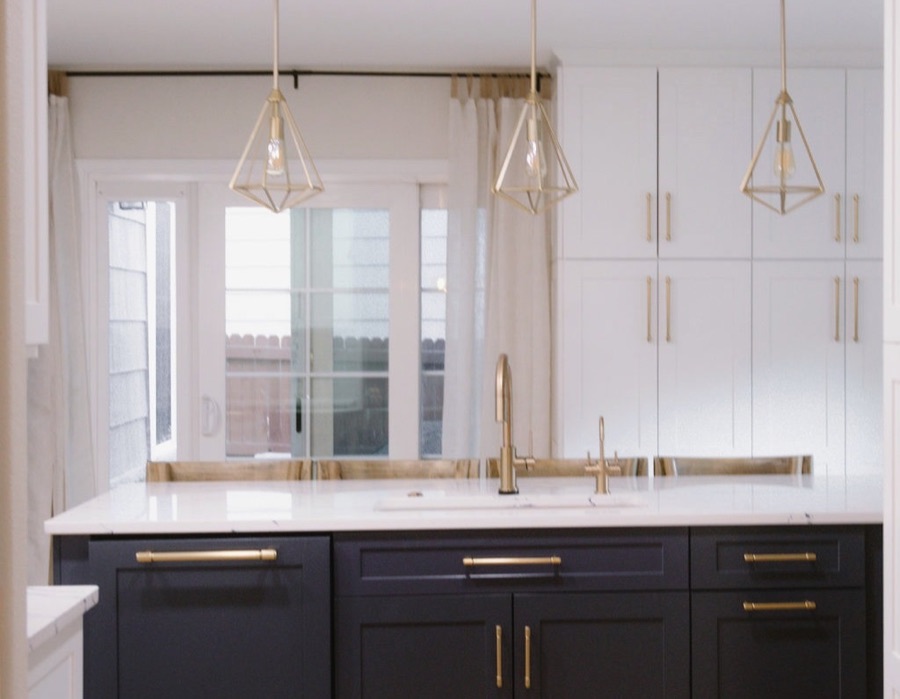 Kitchen sink wall with white cabinets to the ceiling and gold accents — Stonegate main floor renovation in Parker, Colorado