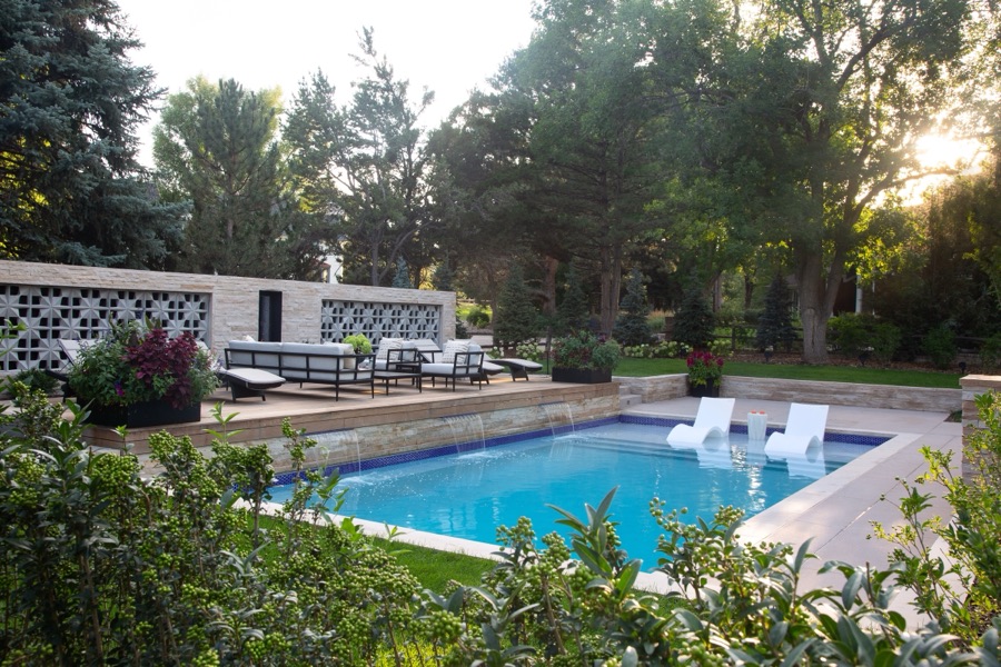 Pool with in-water loungers and mature trees at golden hour — Greenwood Village hidden-detail whole home renovation
