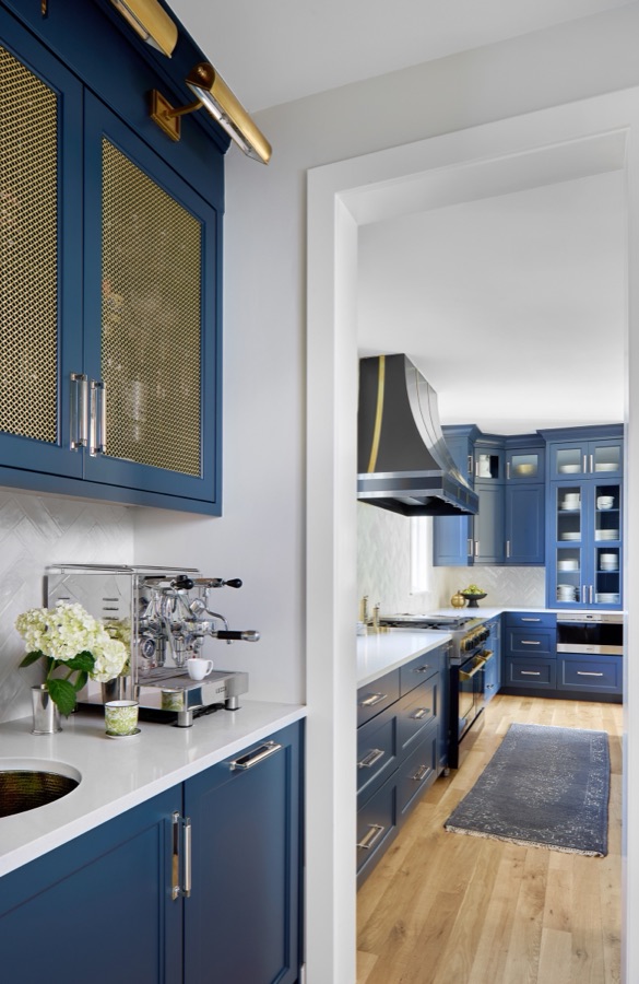 Navy cabinetry with brass hardware and built-in espresso station in the kitchen — Bonnie Brae whole home renovation in Denver