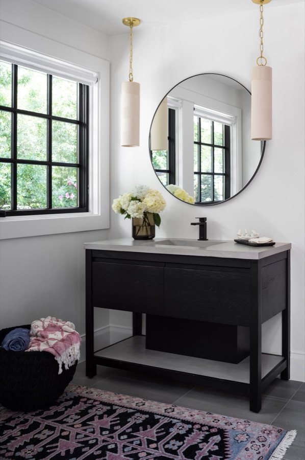 Powder bath with round mirror and blush pendant lights — Greenwood Village hidden-detail whole home renovation