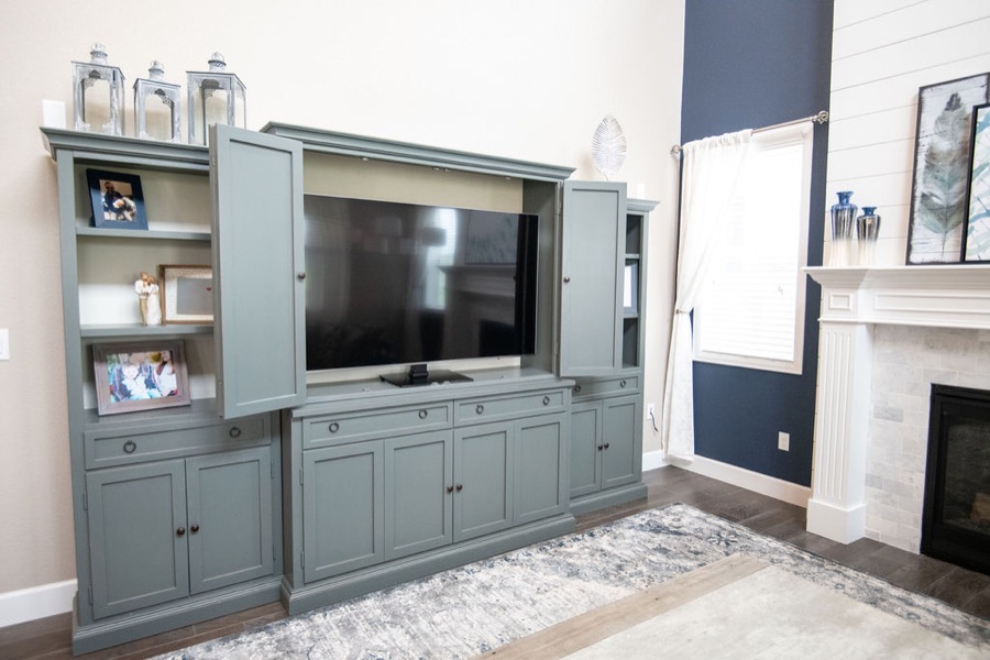 Entertainment center open to reveal the television — Blackstone family room renovation in Aurora, Colorado