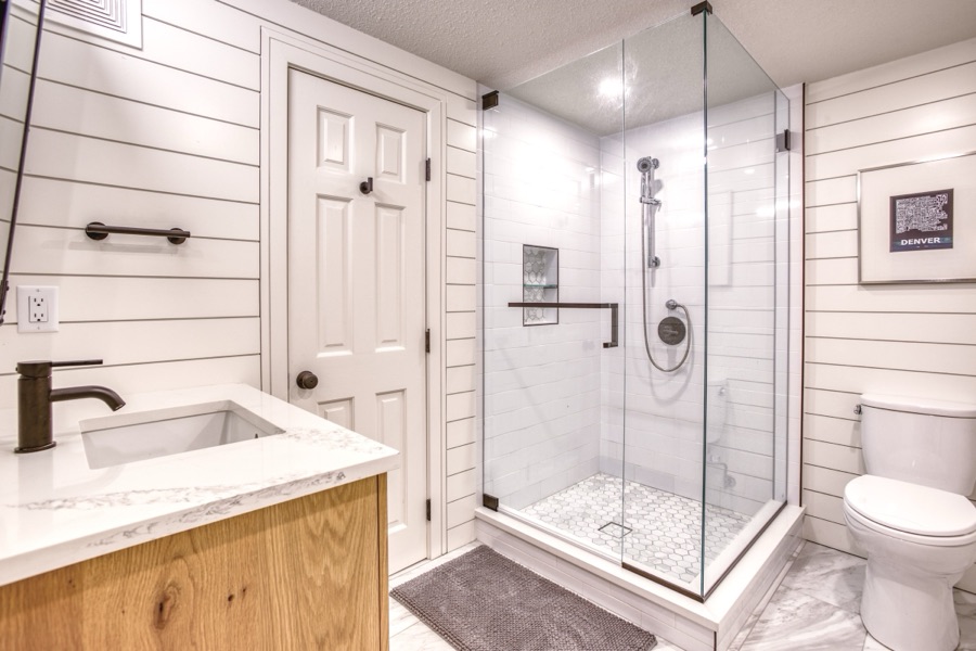 Shower with grab-safe styling and frameless glass — Fulton Street whole house renovation in Greenwood Village