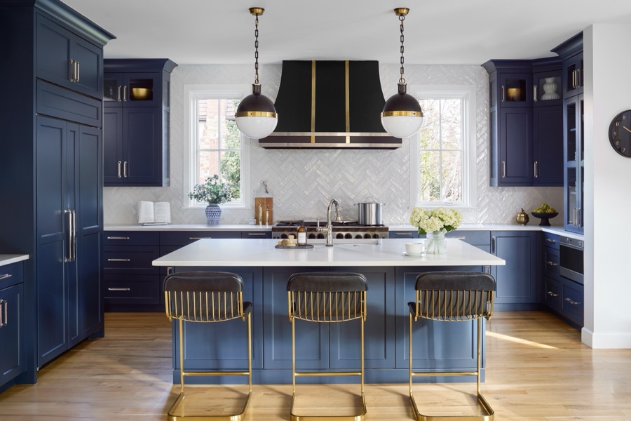 Navy blue kitchen with white quartz island, brass-and-black barstools, and hood pendants — Bonnie Brae whole home renovation in Denver