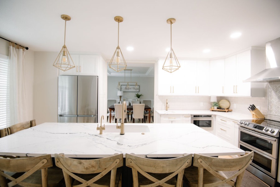 Kitchen overview from the island with layered lighting — Stonegate main floor renovation in Parker, Colorado