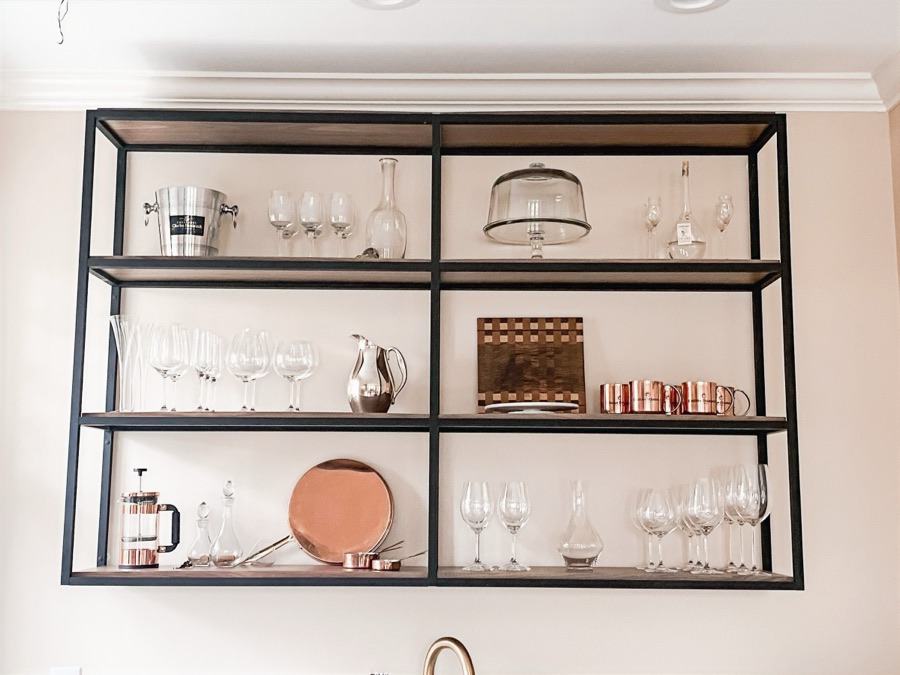 Black metal open shelving styled with copper and glassware — historic Colorado Springs kitchen remodel