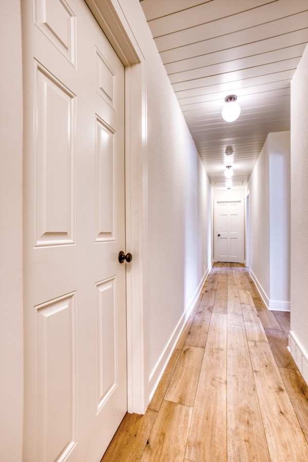Landing with bent-wood accent chair — Fulton Street whole house renovation in Greenwood Village