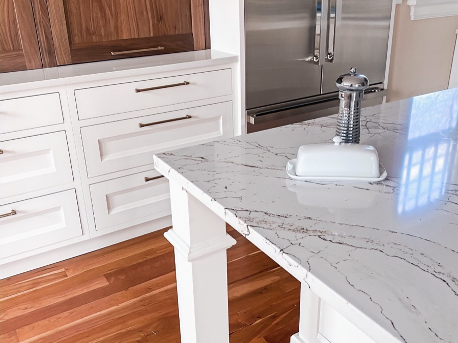 Island with marble-look quartz and warm walnut base — historic Colorado Springs kitchen remodel