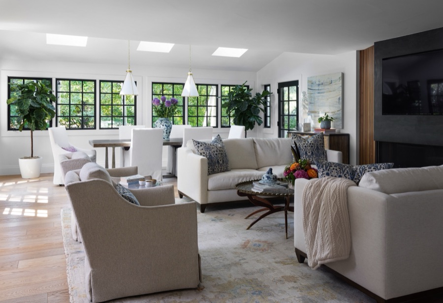 Bright family room with linen sofas and black-framed windows overlooking the yard — Greenwood Village hidden-detail whole home renovation