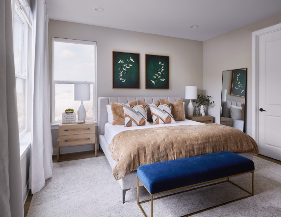 Guest bedroom with upholstered bed, navy bench, and botanical art — The Canyons semi-custom new build in Castle Pines